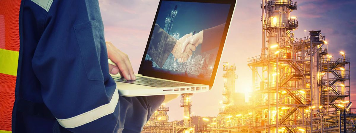 man with laptop outside a plant